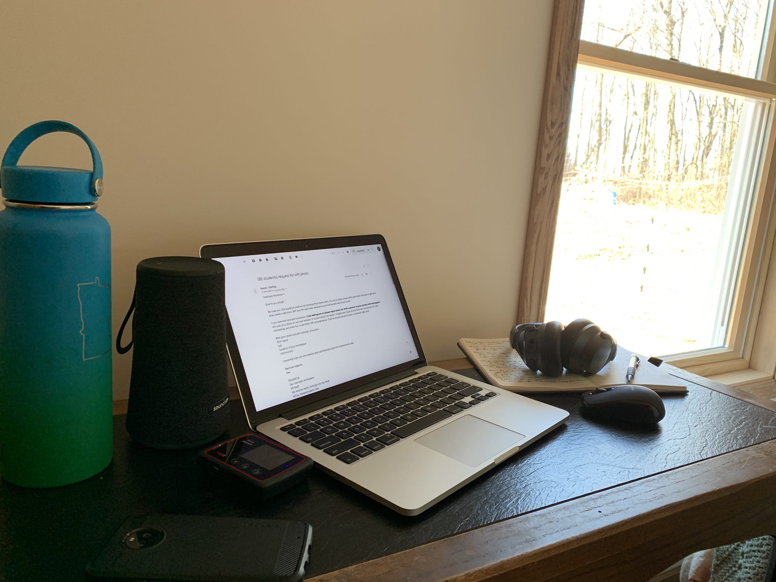 Desk, laptop, bare wall, window